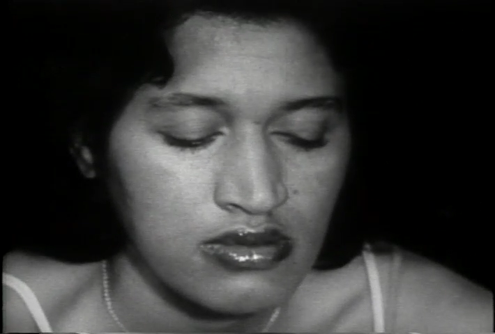 A black and white still from Killing Time showing actress Fronza Woods in close up with her eyes closed