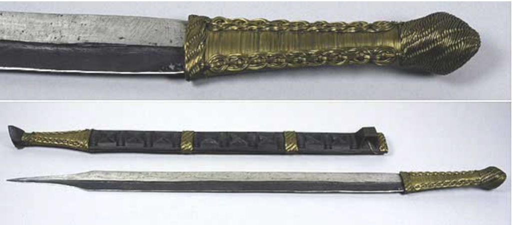 A ceremonial sword with a gold handle, shown in two images on top of each other. The upper image shows a close up of the sword's handle, the lower a wider view of the sword and sheath laid next to each other.